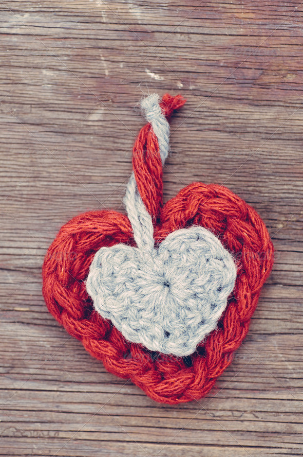 Wool hearts on old wooden background