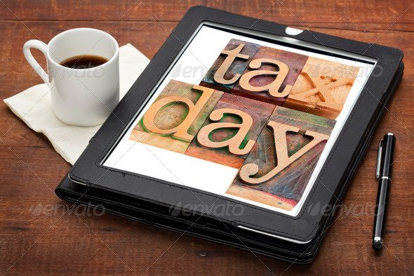 tax day – isolated words in vintage wooden letterpress printing blocks on a digital tablet with a cup of coffee