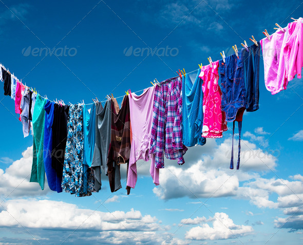 clothes hanging to dry on clothesline on blue sky