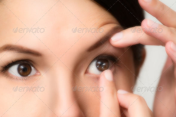 Woman about to place a contact lens in her eye