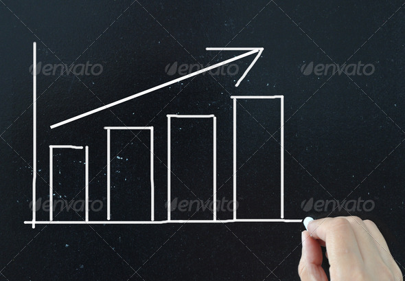 Business chart with an upward trend arrow drawn on a chalkboard