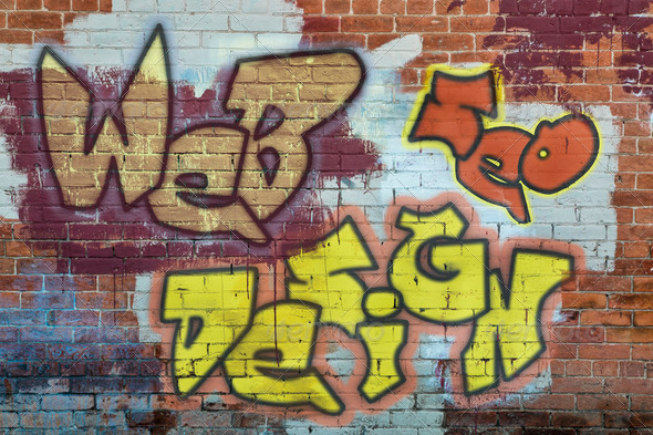 web and SEO design – colorful graffiti text on a grunge brick wall