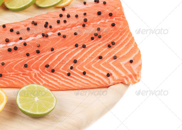 Raw salmon fillet on platter.