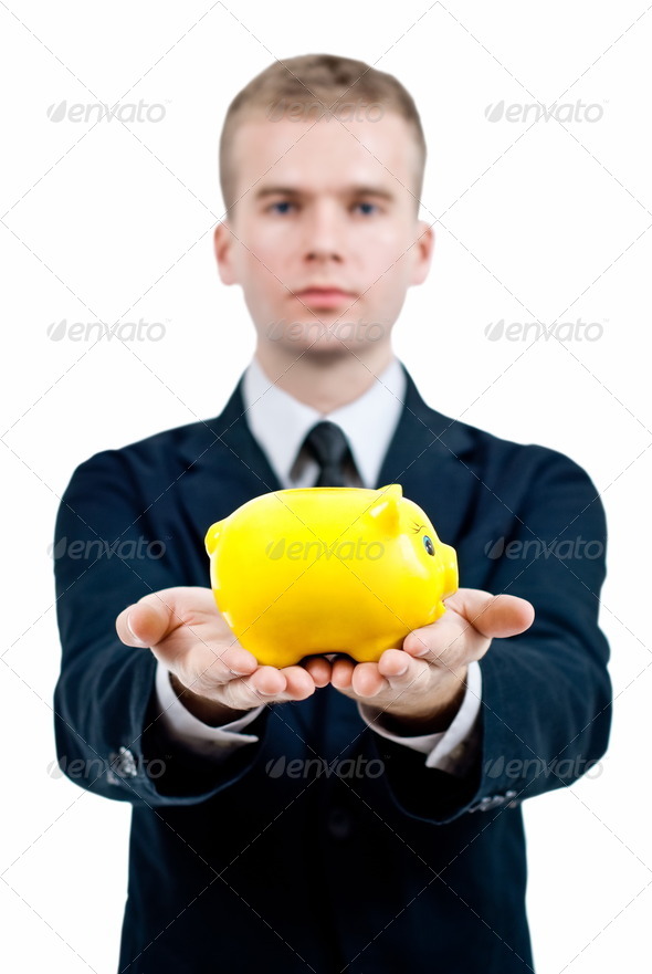 Businessman holding piggy bank in his hand. (Misc) Photo Download