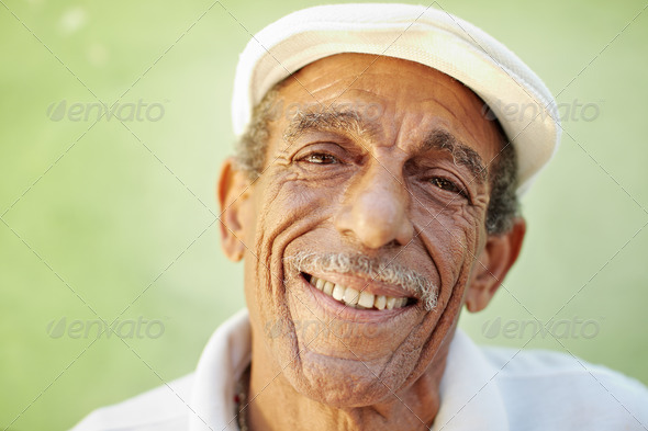 aged latino man smiling at camera - Stock Photo - Images