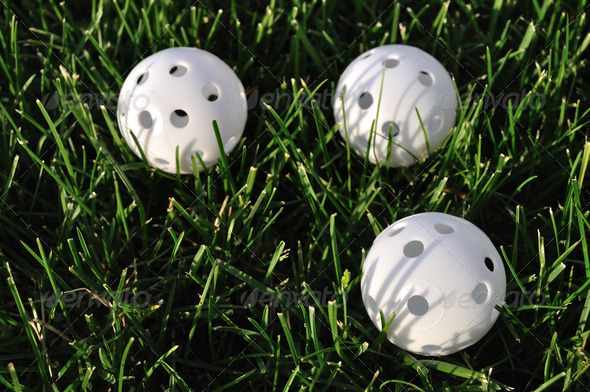 Three White Plastic Wiffle Golf Balls