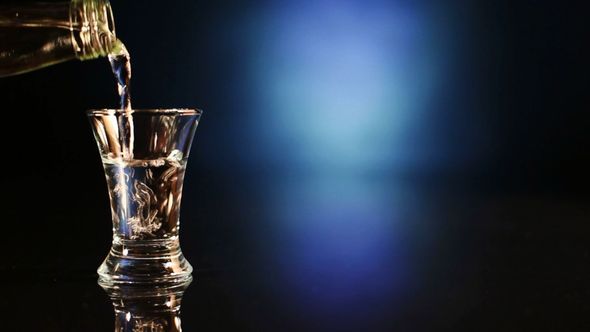Bottle Pours Vodka Into A Pile Bottle Pours Vodka Into A Pile