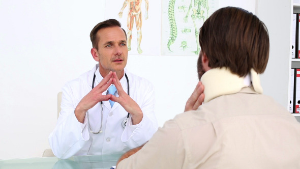 Doctor Speaking With His Patient In A Neck Brace Doctor Speaking With His Patient In A Neck Brace