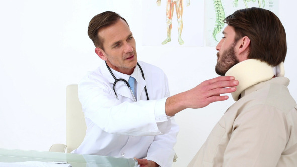 Doctor Checking His Patient In A Neck Brace Doctor Checking His Patient In A Neck Brace