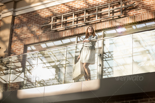 young woman walking with shopping bag at terminal (Misc) Photo Download