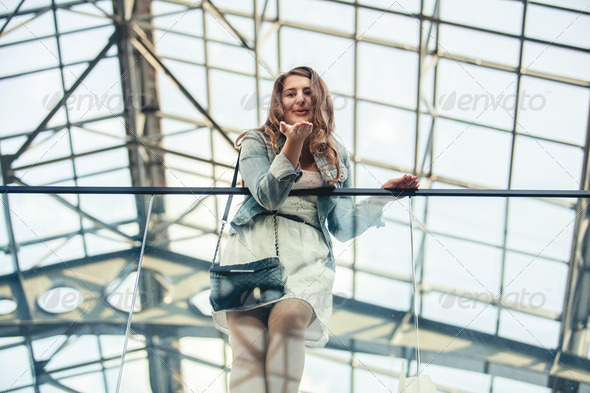 woman blowing air kiss from hand at airport (Misc) Photo Download