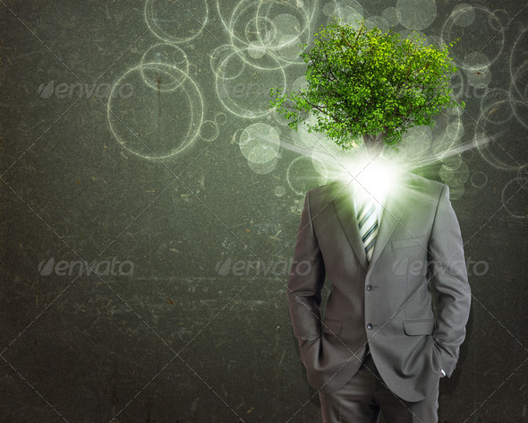 Businessman stand with green tree and bright light instead his head (Misc) Photo Download