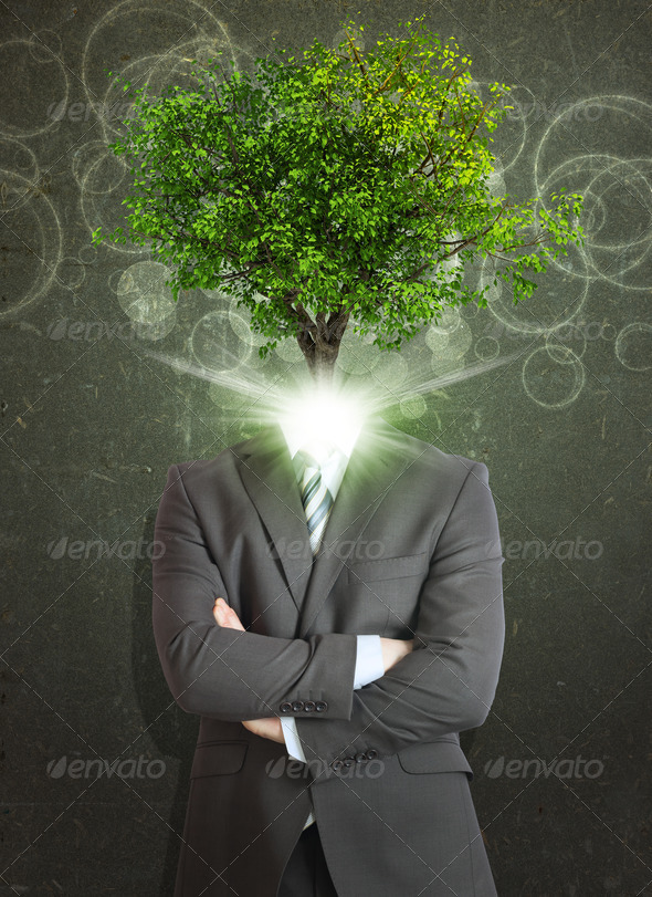 Businessman stand with green tree and bright light instead his head (Misc) Photo Download