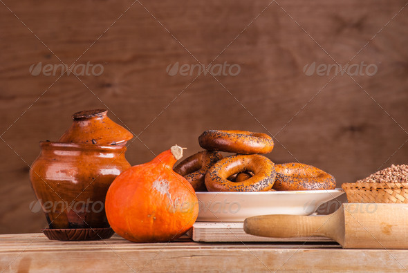 Cut loaf of fresh bread on burlap on wooden table (Misc) Photo Download
