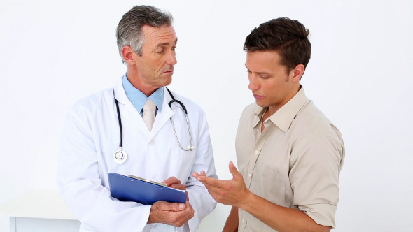 Patient Speaking To His Doctor Holding Clipboard Patient Speaking To His Doctor Holding Clipboard
