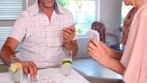 Happy Couple Playing Cards Together Happy Couple Playing Cards Together