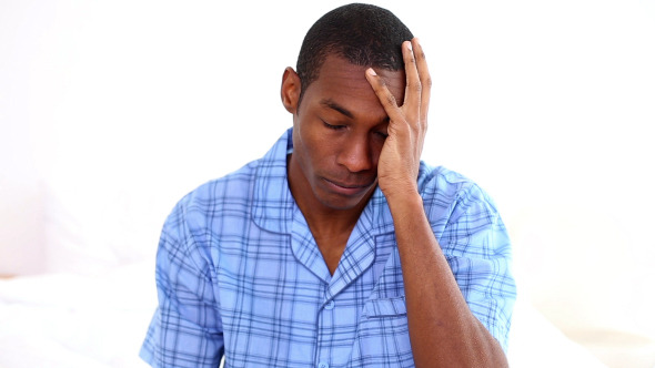Hungover Man Touching His On The End Of His Bed Hungover Man Touching His On The End Of His Bed