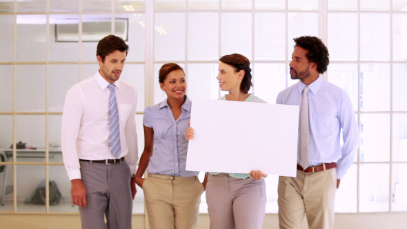 Business Team Showing A White Card Business Team Showing A White Card