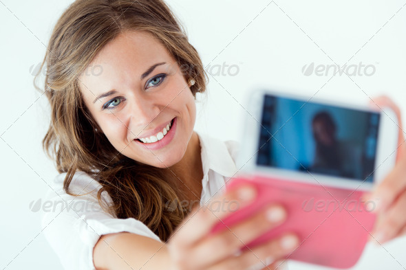 Beautiful blonde girl taking selfie. Isolated on white. (Misc) Photo Download