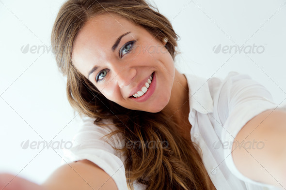 Beautiful blonde girl taking selfie. Isolated on white. (Misc) Photo Download