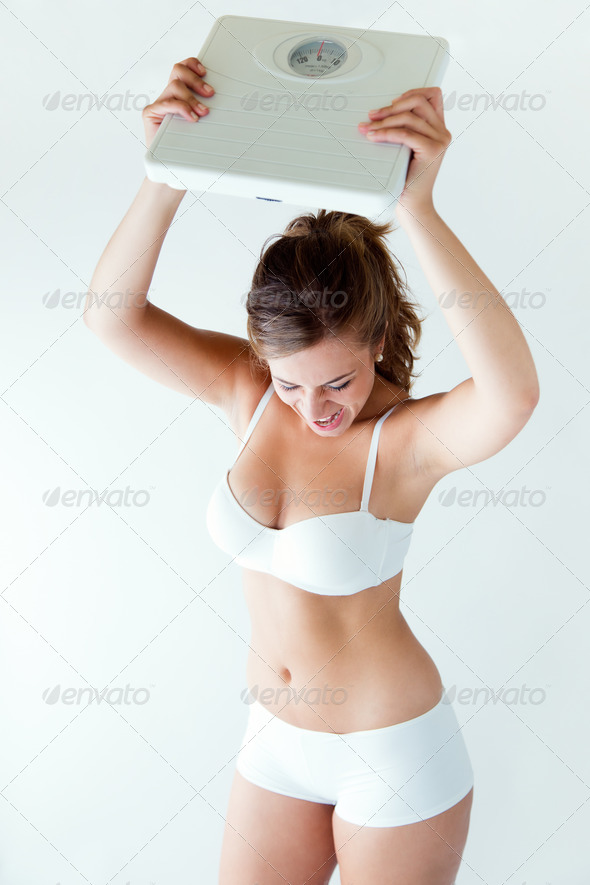 Frustrated woman with scale. Isolated on white. (Misc) Photo Download