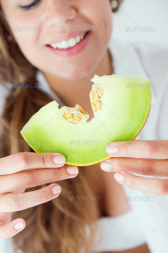 Young woman in underwear eating melon. Isolated on white. (Misc) Photo Download