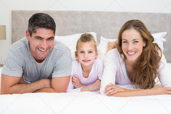 Portrait of happy family in bed (Misc) Photo Download