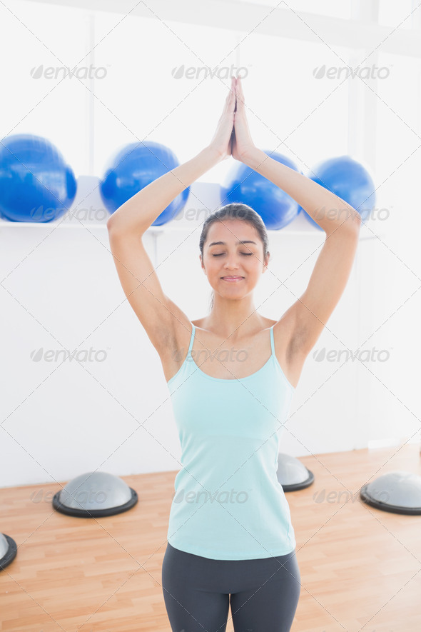 Beautiful young sporty woman with joined hands in fitness studio (Misc) Photo Download