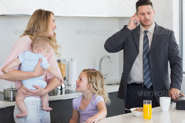 Family of four at breakfast table in kitchen (Misc) Photo Download