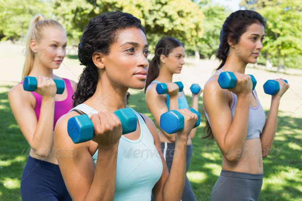 Group of multiethnic sporty women lifting dumbbells in park (Misc) Photo Download