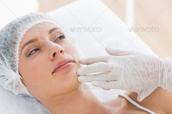 Beautiful young woman recieving botox injection in hospital (Misc) Photo Download