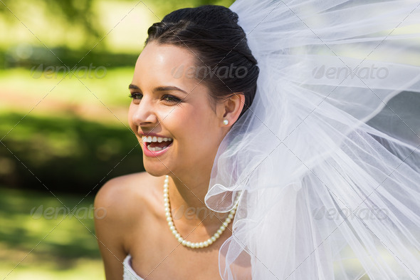 Close-up of a cheerful young beautiful bride in the park (Misc) Photo Download