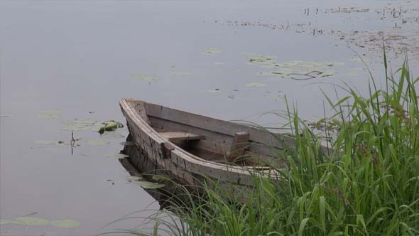 An Old Wooden Boat In The River An Old Wooden Boat In The River
