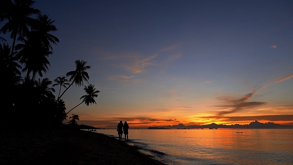 Couple%20Walking%20on%20Sunset%20Beach