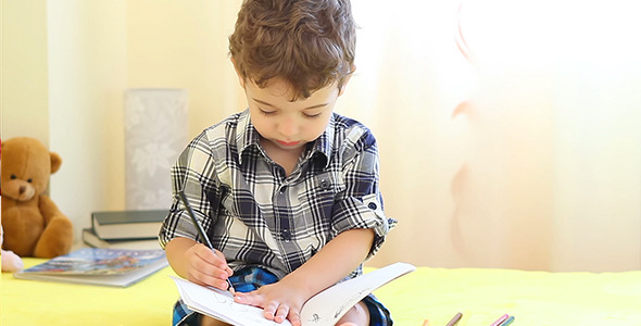 Little Boy Drawing His Hand Little Boy Drawing His Hand