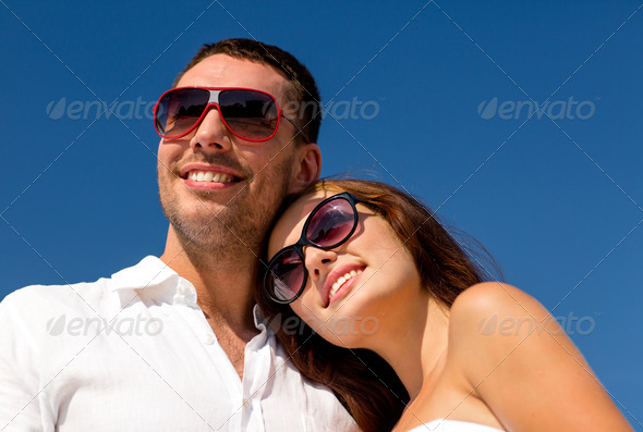 smiling couple over blue sky background (Misc) Photo Download