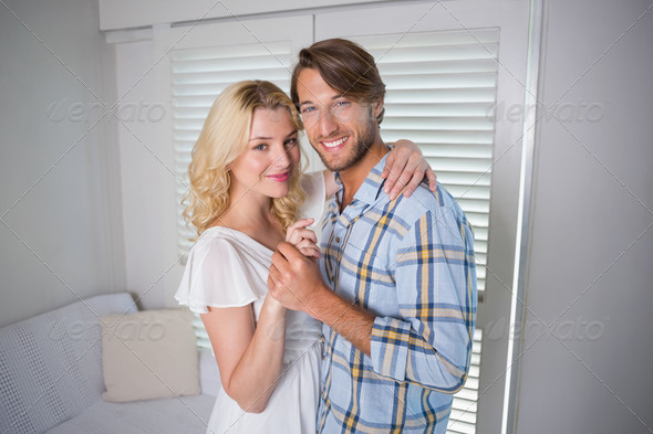 Cute young couple dancing together at home in the living room (Misc) Photo Download