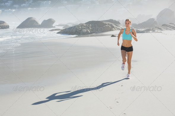 Fit woman jogging on the beach on a sunny day (Misc) Photo Download