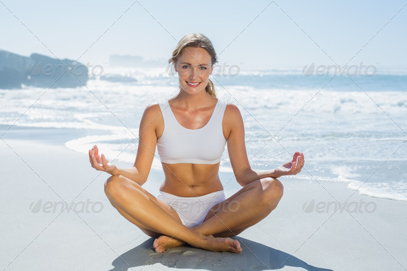 Gorgeous blonde in lotus pose by the sea on a sunny day (Misc) Photo Download