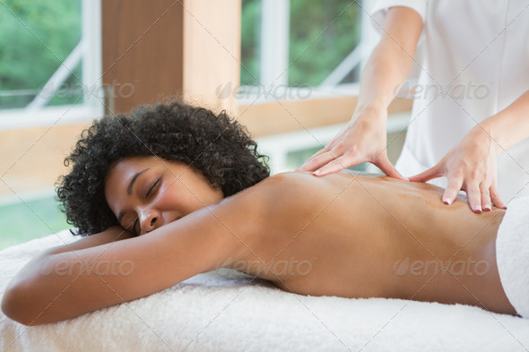 Gorgeous woman enjoying a back massage at the health spa (Misc) Photo Download