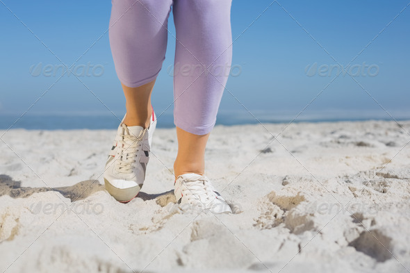 Sporty womans feet on the sand on a sunny day (Misc) Photo Download