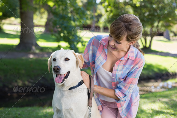 Cute blonde with her labrador dog in the park on a sunny day (Misc) Photo Download