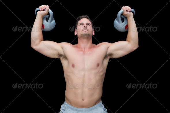 Strong bodybuilder lifting up kettlebells on black background (Misc) Photo Download