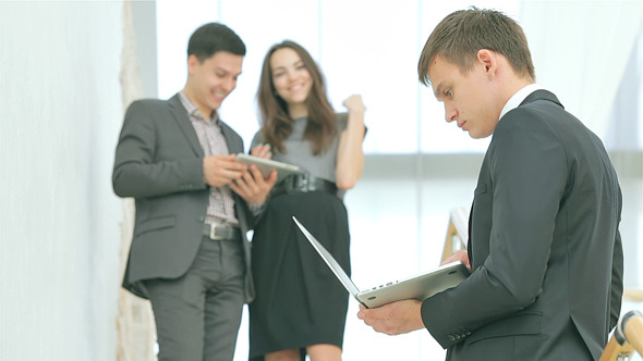 Successful Businessman Holding a Laptop Successful Businessman Holding a Laptop