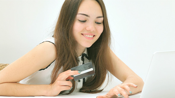 Pretty Girl Sitting and Making On-line Purchases Pretty Girl Sitting and Making On-line Purchases