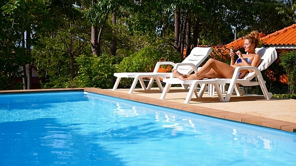 Using Smart Phone by the Poolside Using Smart Phone by the Poolside