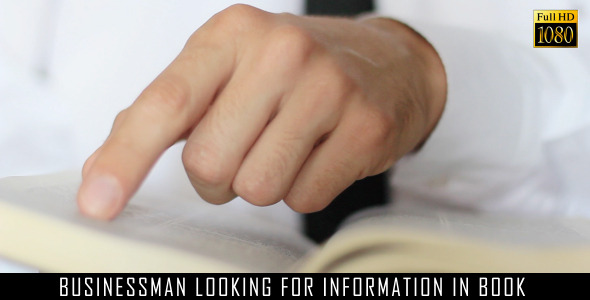 Businessman Looking For Information In Book Businessman Looking For Information In Book