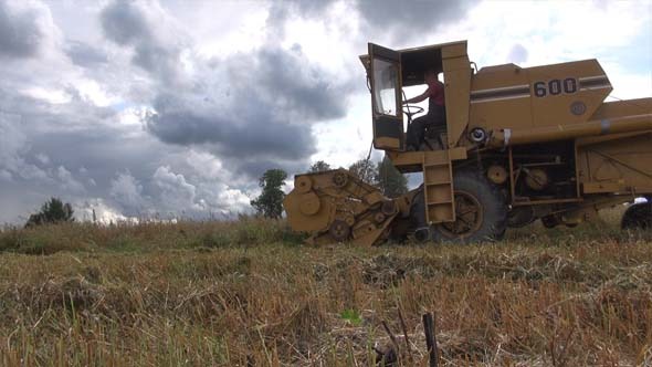 Combine Harvester And Oat Field Combine Harvester And Oat Field