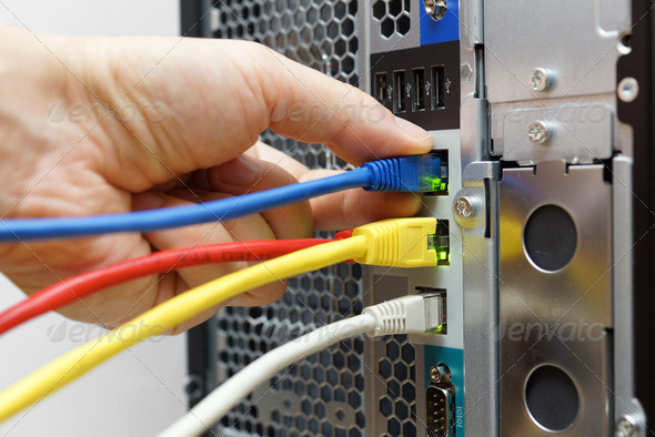 system administrator connecting network cables to data server
