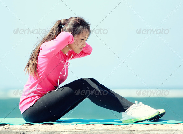 woman doing workout in the beach